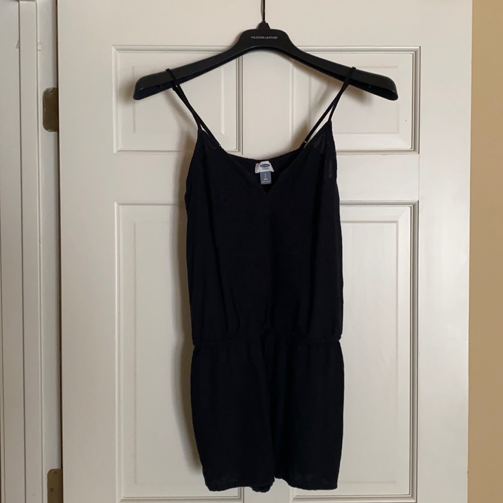 Black romper with embroidered detail.